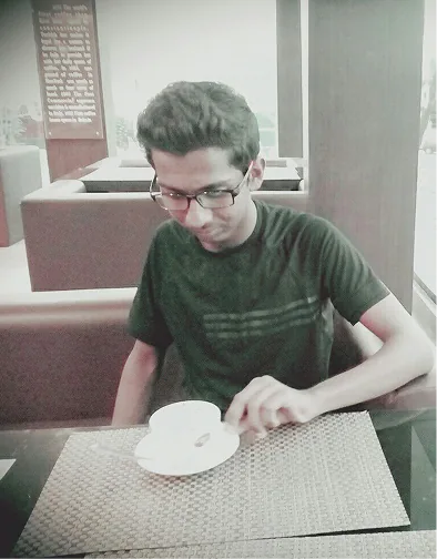 Rohan sitting at a coffee table